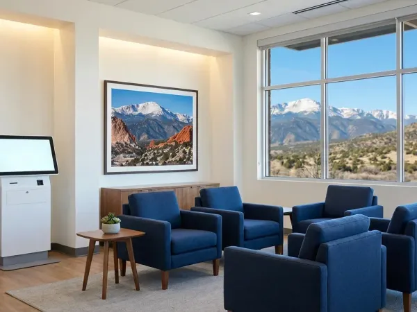 Friendly dentist and hygienist with a patient in a modern Colorado Springs dental office