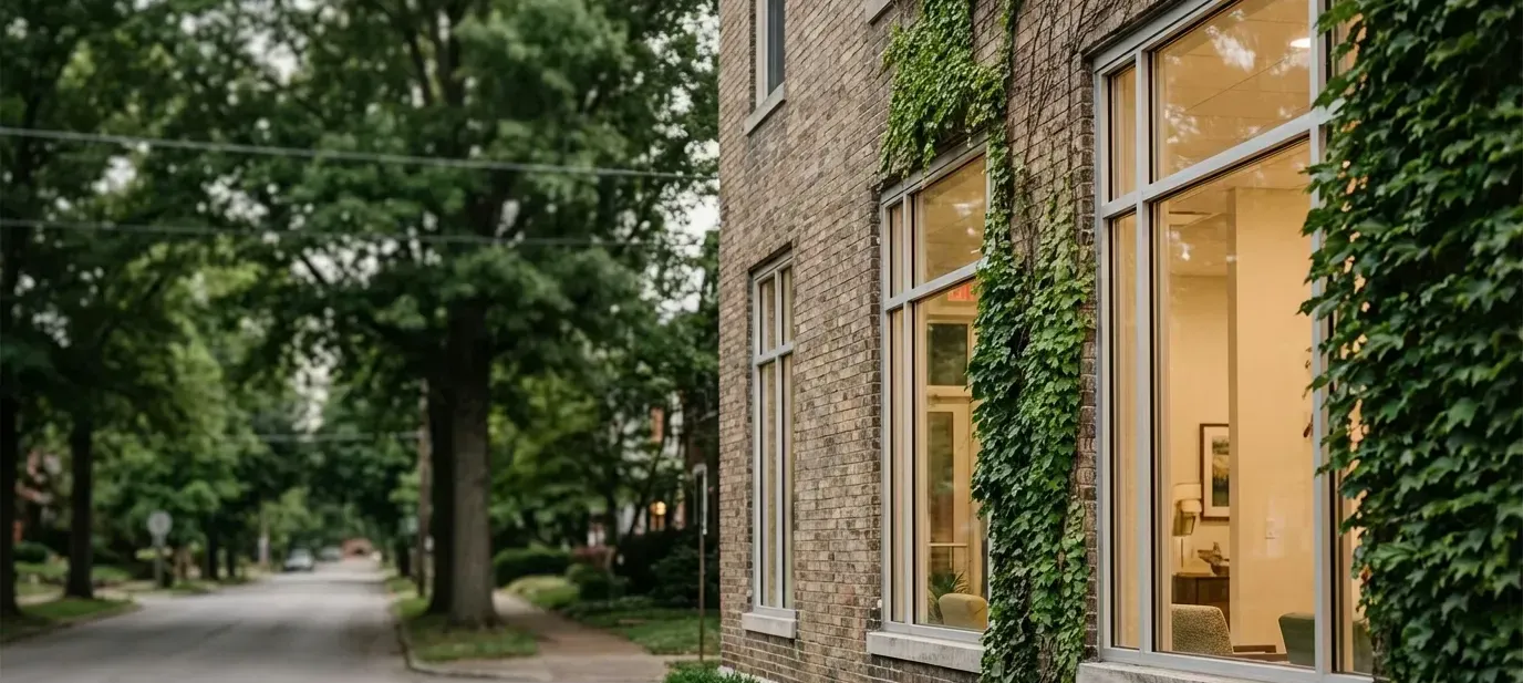 Modern independent medical practice in a converted Louisville brick building with ivy exterior and warm interior lighting
