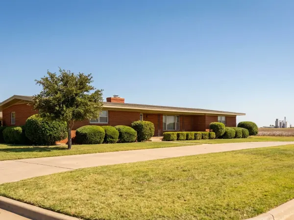 Real estate agent consulting with clients about home purchase in Lubbock, TX neighborhood