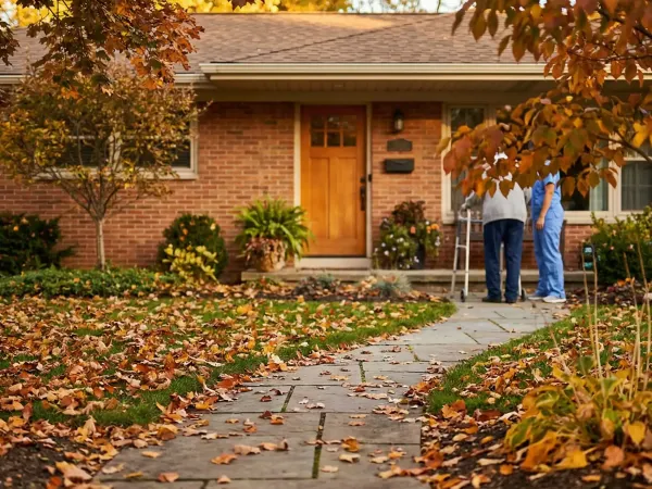 Professional home caregiver assisting elderly woman in a bright Monroe County residential kitchen, Rochester, NY