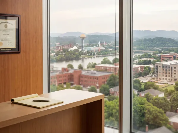 Professional law office consultation room in downtown Knoxville, Tennessee with Tennessee River and Appalachian foothills visible through window