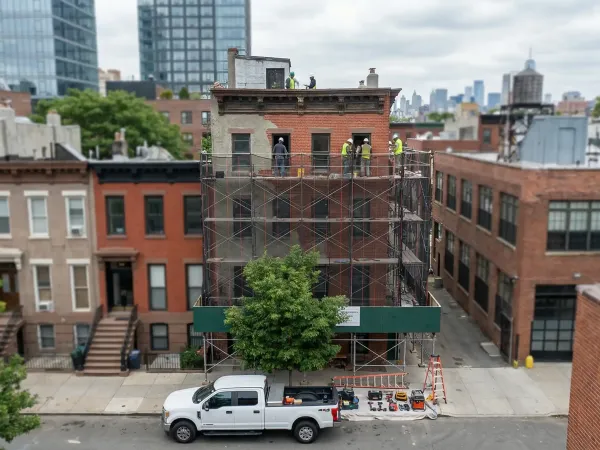 Professional contractor reviewing renovation plans at an active Newark NJ construction site