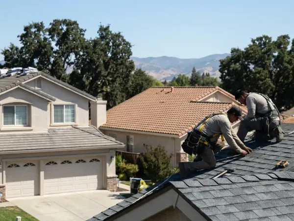 Professional roofing contractor reviewing a completed tile roof installation on a Roseville, CA suburban home