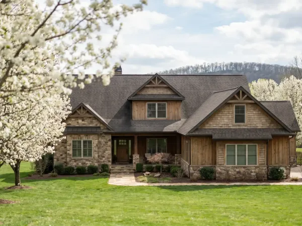 Real estate agent showing a craftsman-style home to a young couple in a Springdale, AR subdivision on a spring morning