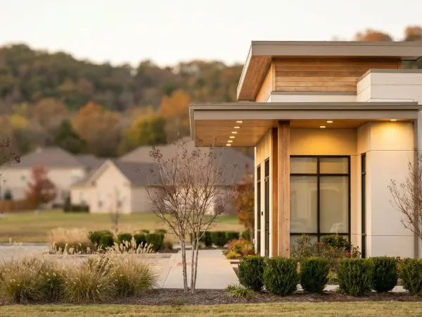 Medspa aesthetician in white lab coat administering injectable treatment to a relaxed female client in a modern Rogers, AR treatment room with clean white surfaces and professional clinical lighting